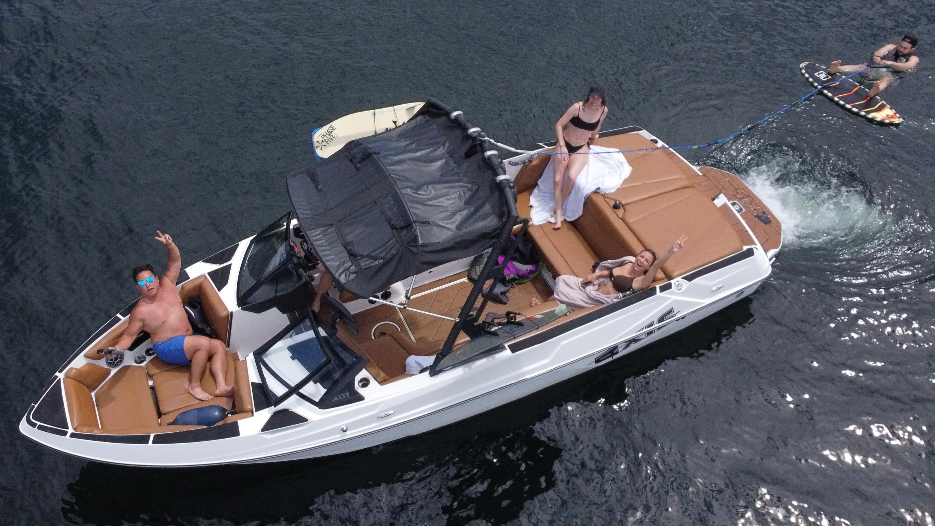 Aerial view of Bella Onda Axis T-23 wakeboat with friends and wakesurfer on Lake Zug