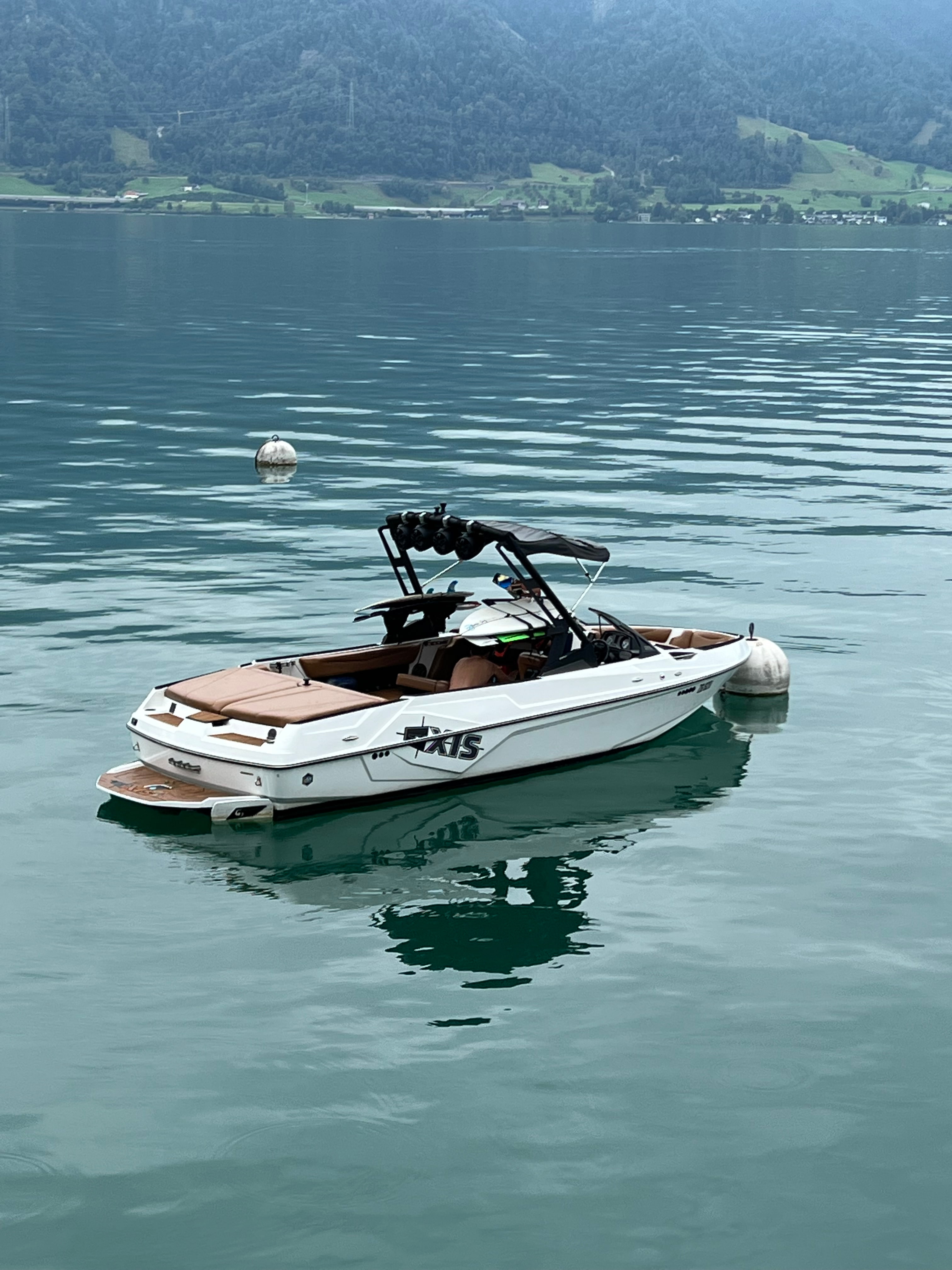Axis wakeboat on the buoy on Lake Zug